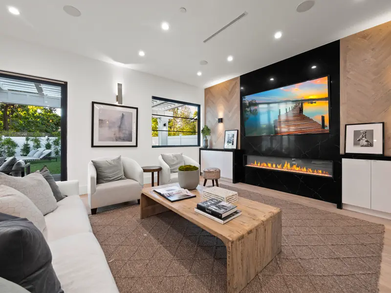 Slab fireplace in Los Angeles, CA: black slab media wall with a linear fireplace