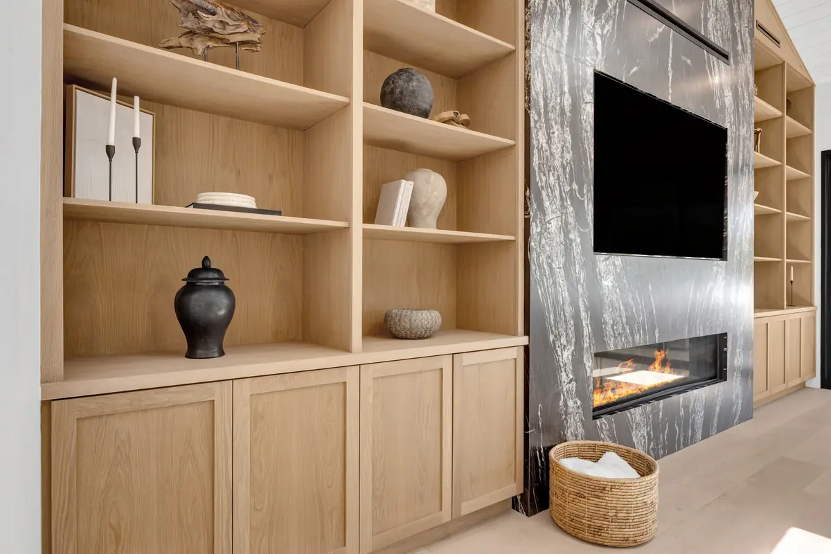 Slab fireplace in Porter Ranch, CA: close view of a dark veined slab fireplace surround with a linear fire