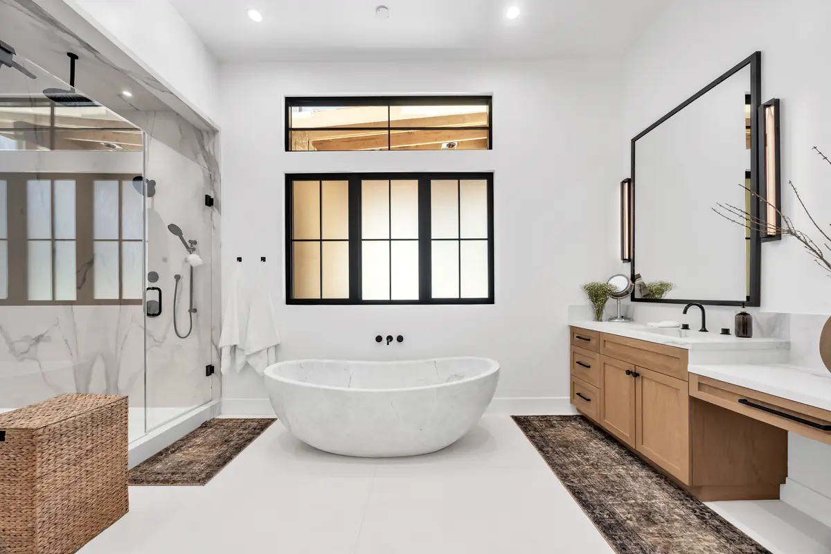 Vanity countertop in Porter Ranch, CA: primary bath with a freestanding tub and an oak vanity with a white countertop