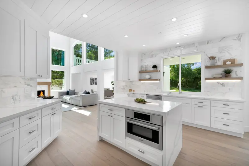 Kitchen countertops in Sherman Oaks, CA: veined white countertops on a kitchen island and perimeter