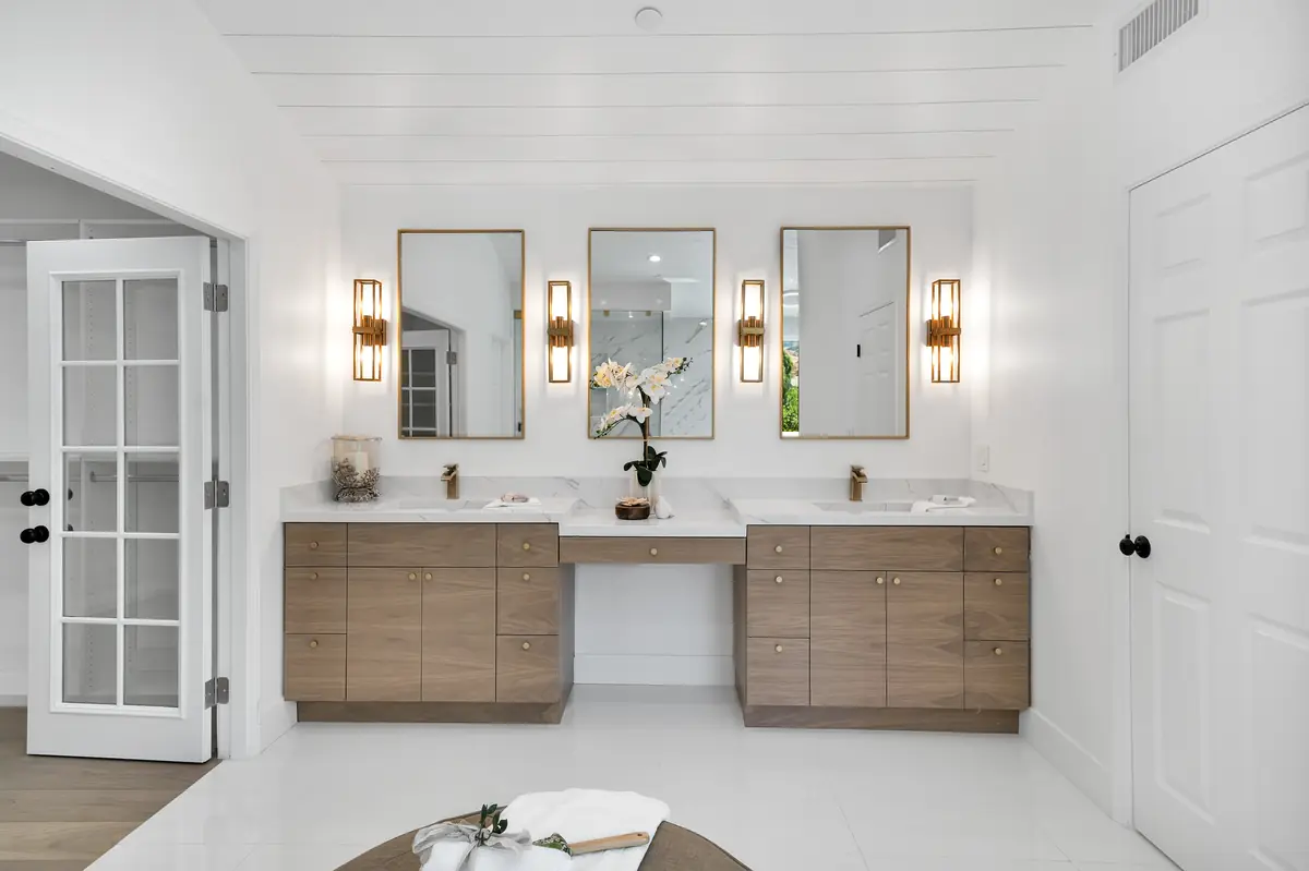 Vanity countertop in Sherman Oaks, CA: double vanity with a white countertop and three mirrors