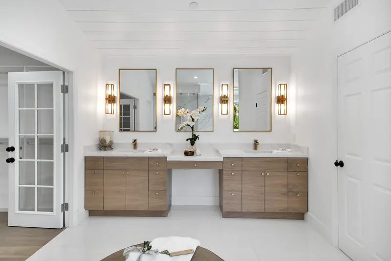 Vanity countertop in Sherman Oaks, CA: double vanity with a white countertop and three mirrors